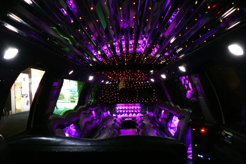 Rear cabin of a Lincoln Navigator L, captain’s chairs and ambient lighting